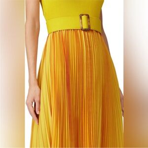 Pleated , belted yellow dress